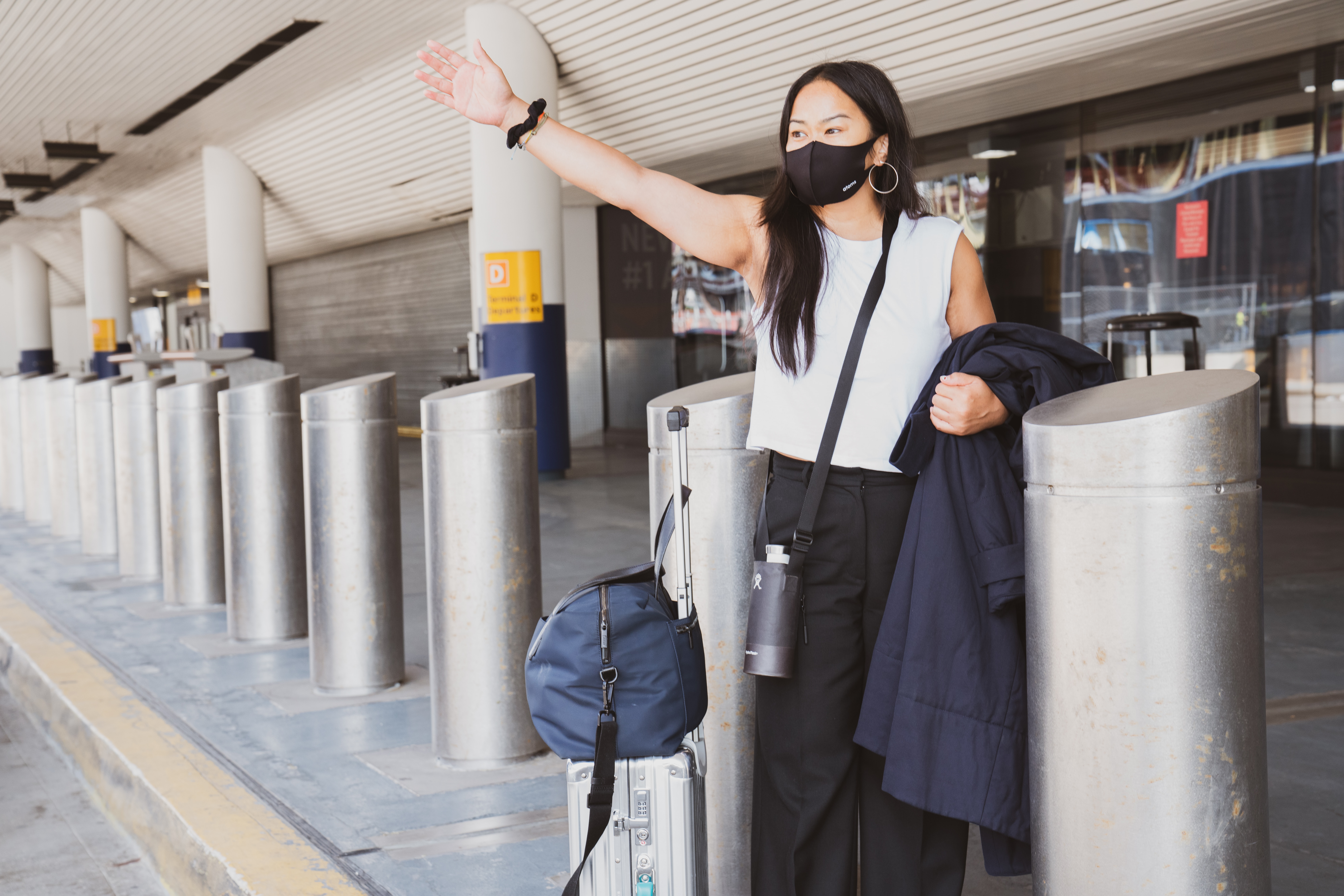 girl with black mask departing at airport, luggages