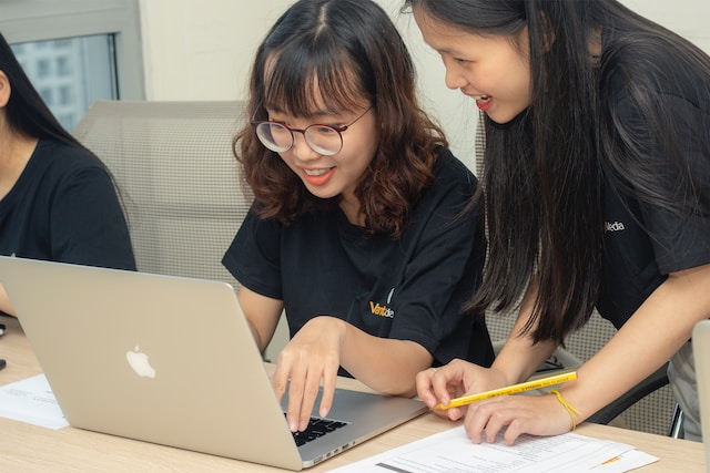 asian students studying together with Macbook