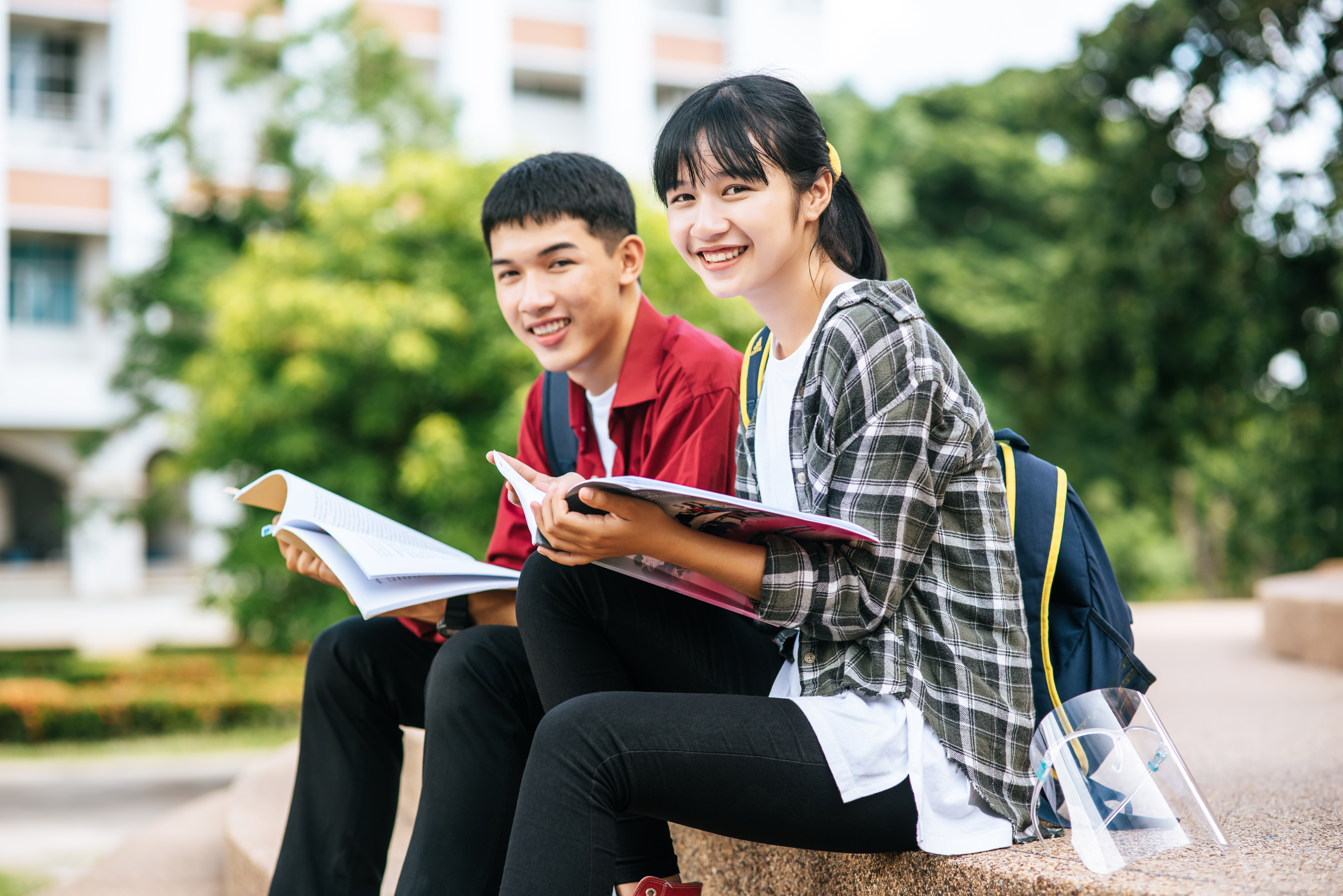 two students sitting outside