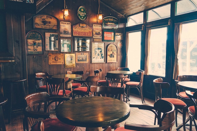 British pub with big windows, wooden tables and chairs 
