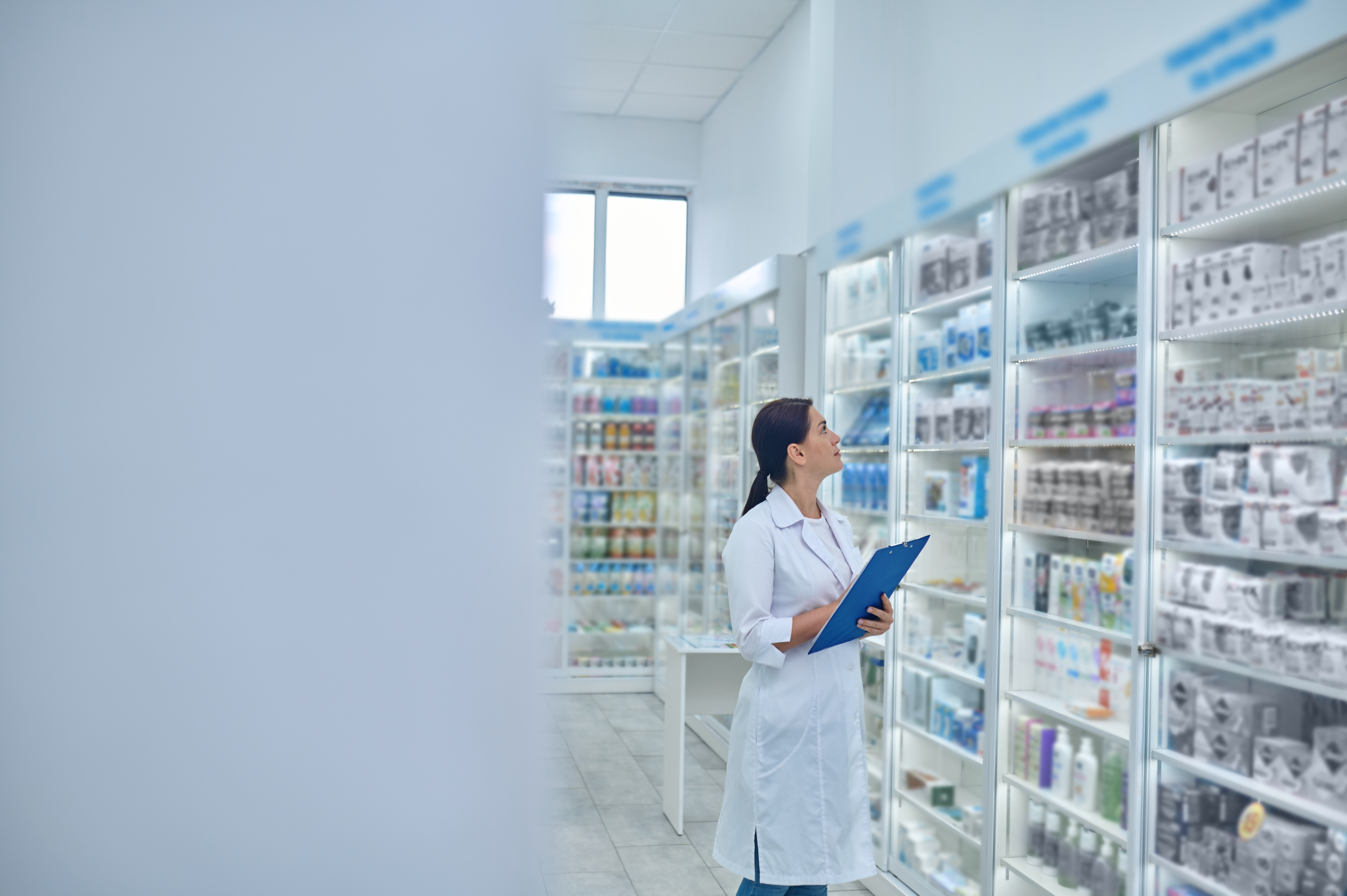 Pharmacist checking medicines at drugstore 